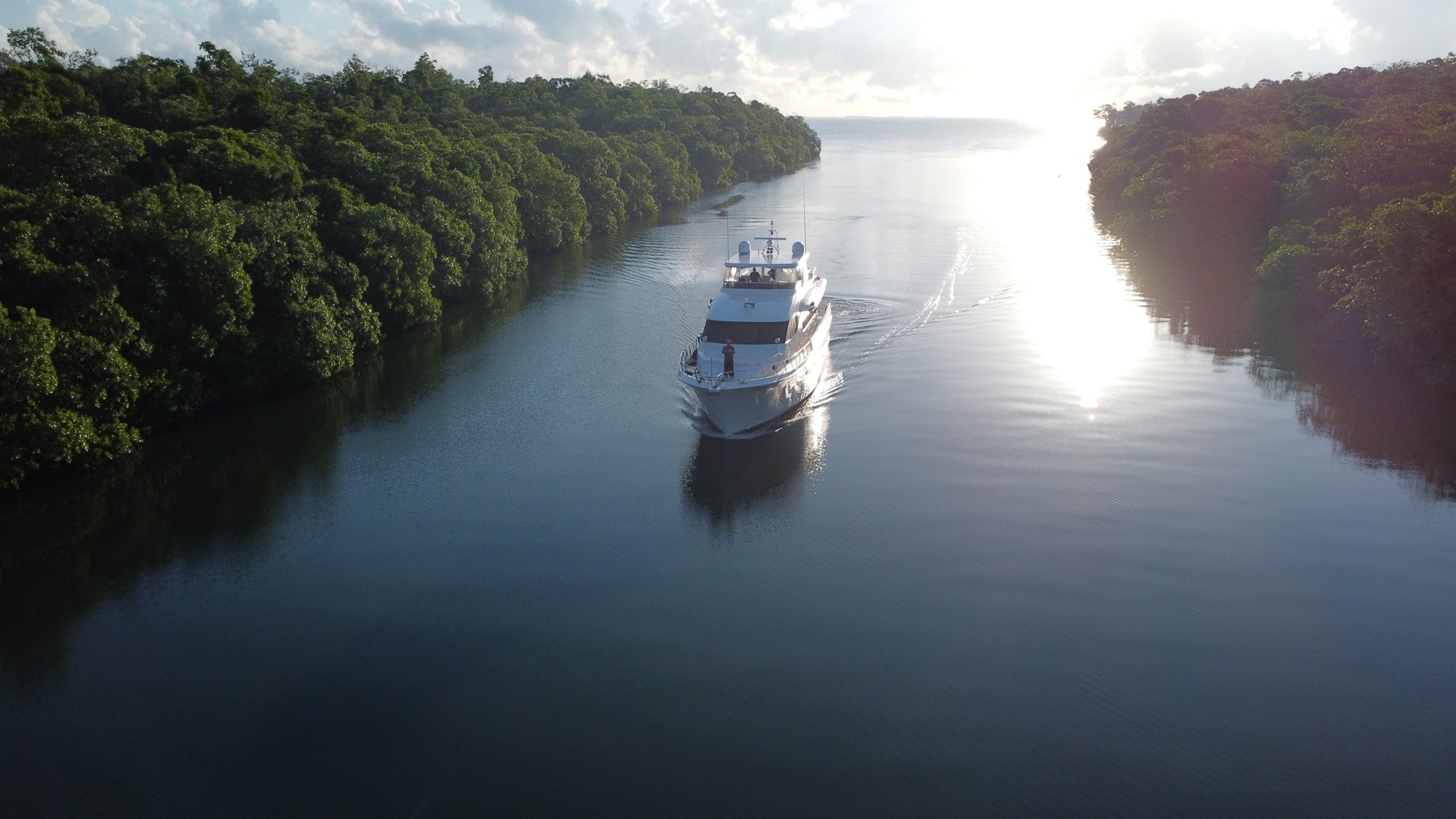 A yacht on the Mangrove waterway heading toward the open Caribbean